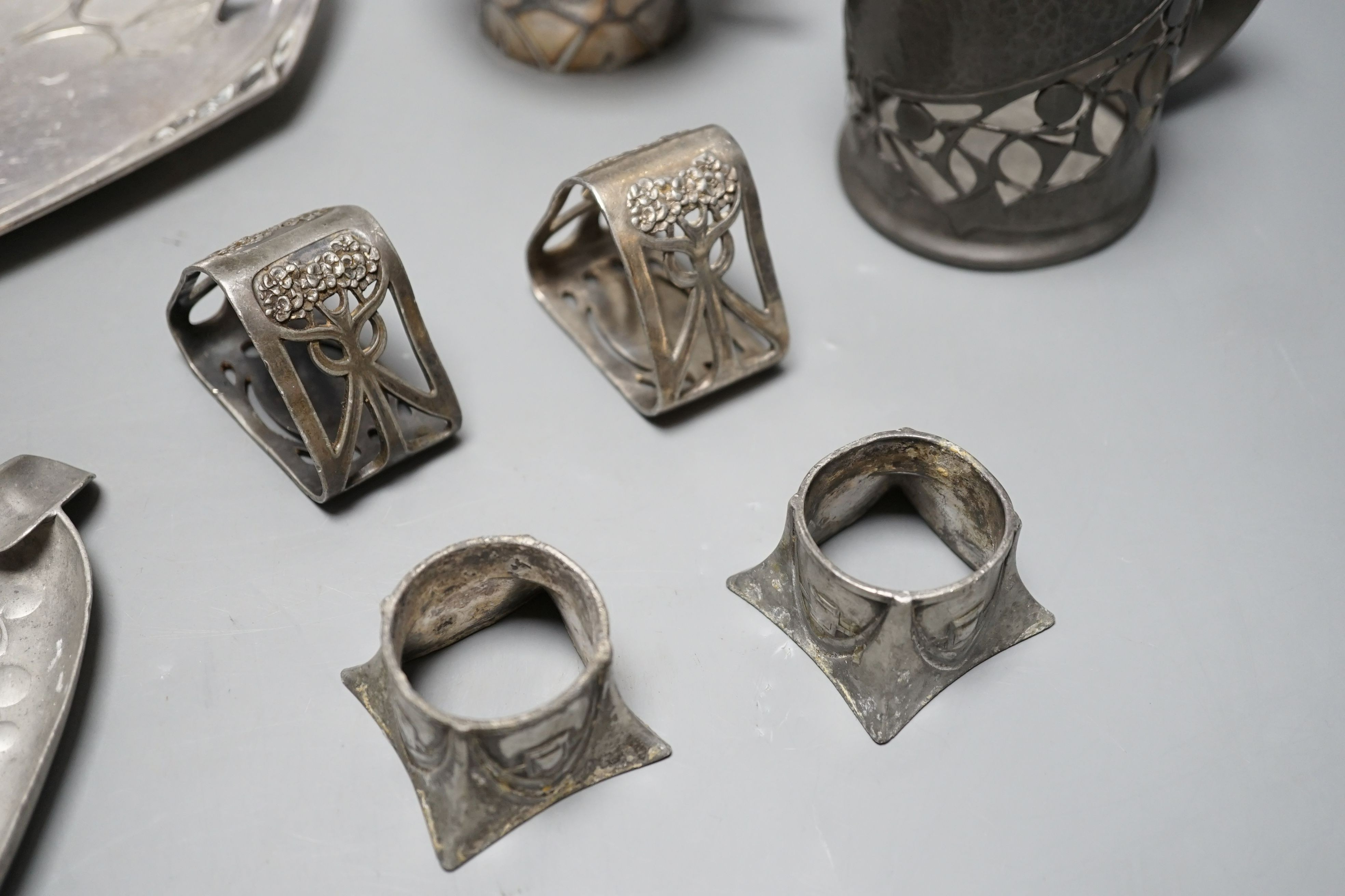An Arts and Crafts Tudric pewter mug, stamped 534, a pair of WMF napkin rings together with other pewter and metal items, pewter mug 8cms high (9)